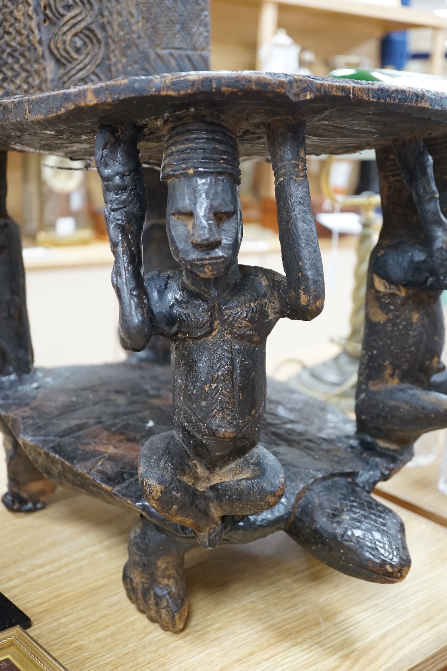 An African tribal carved hardwood chair, possibly Congo. 76cm tall